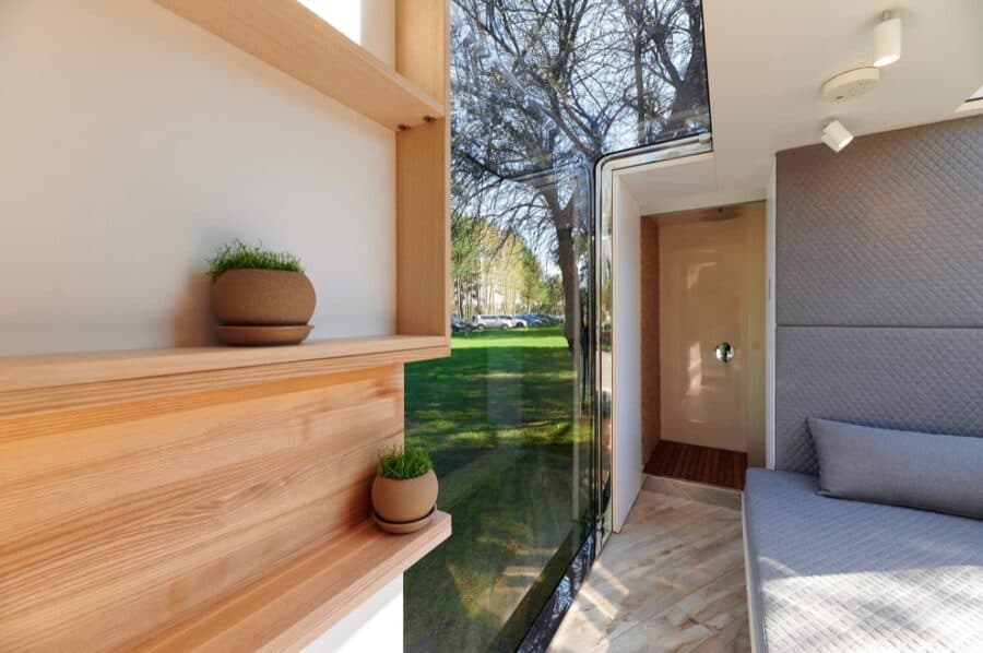 Compact tiny house interior with modern design and large windows.
