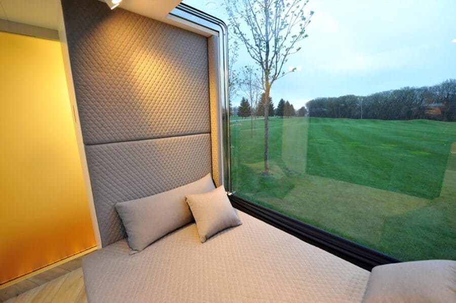Compact microhome bedroom with cozy bed and modern decor.
