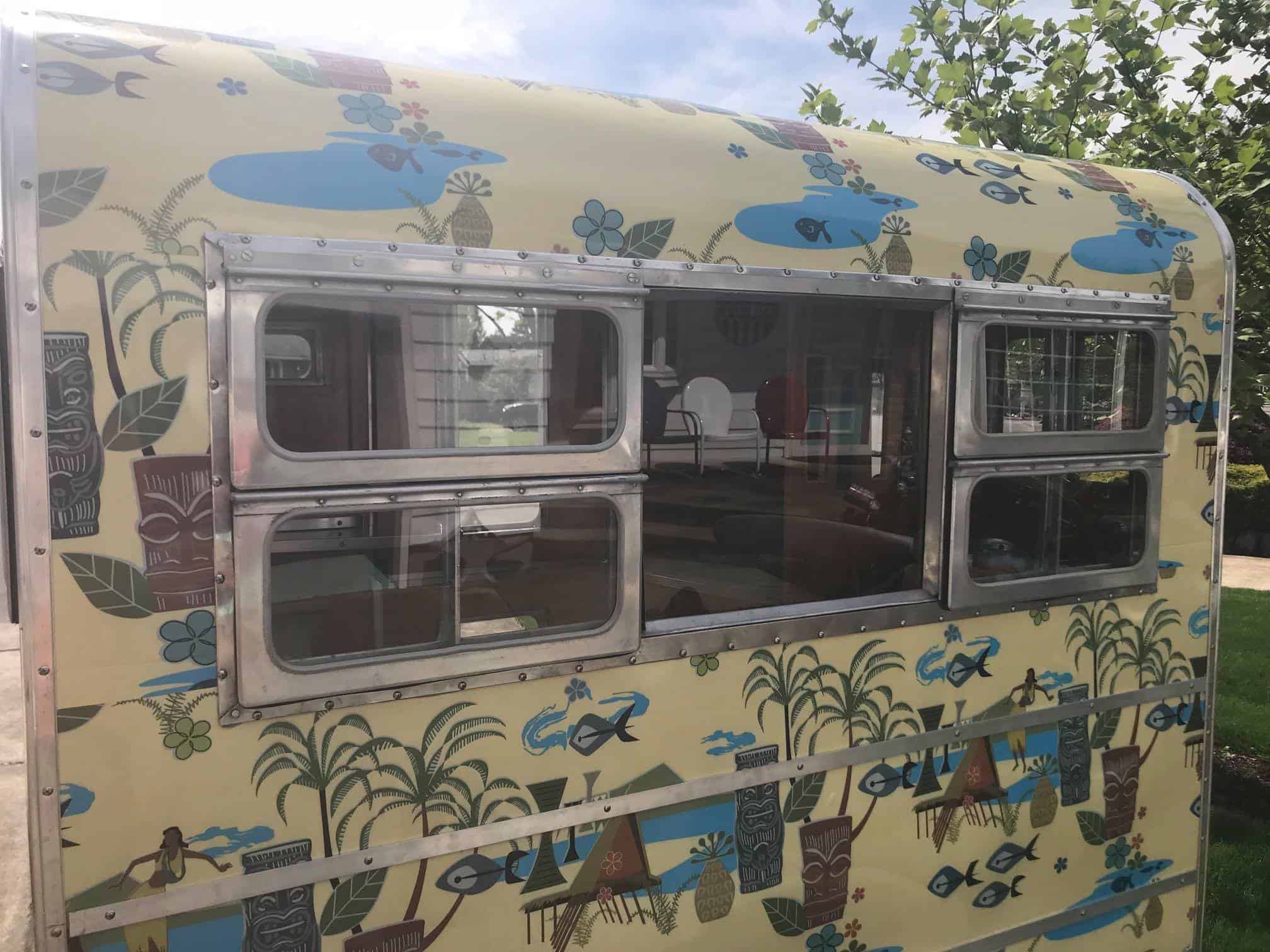 The Mighty Munchkin at a vintage trailer rally surrounded by larger campers