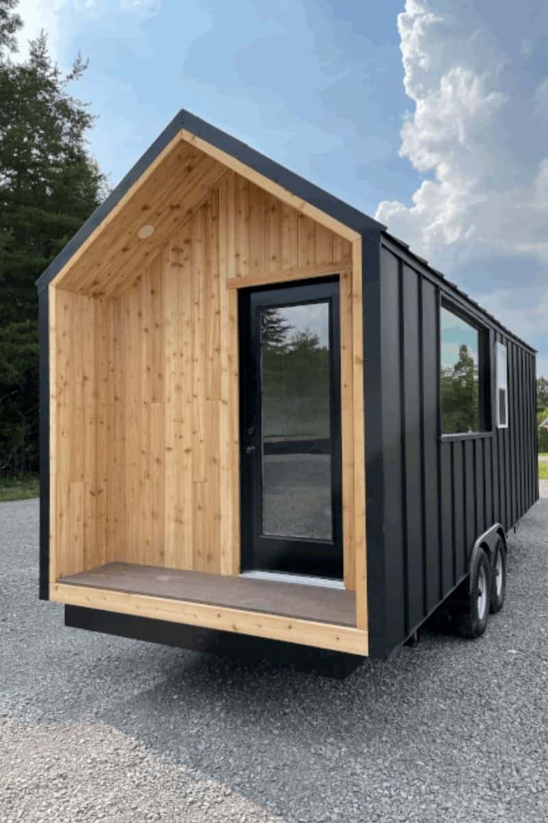 Cedar covered porch entry alcove on the Minimalist black tiny house
