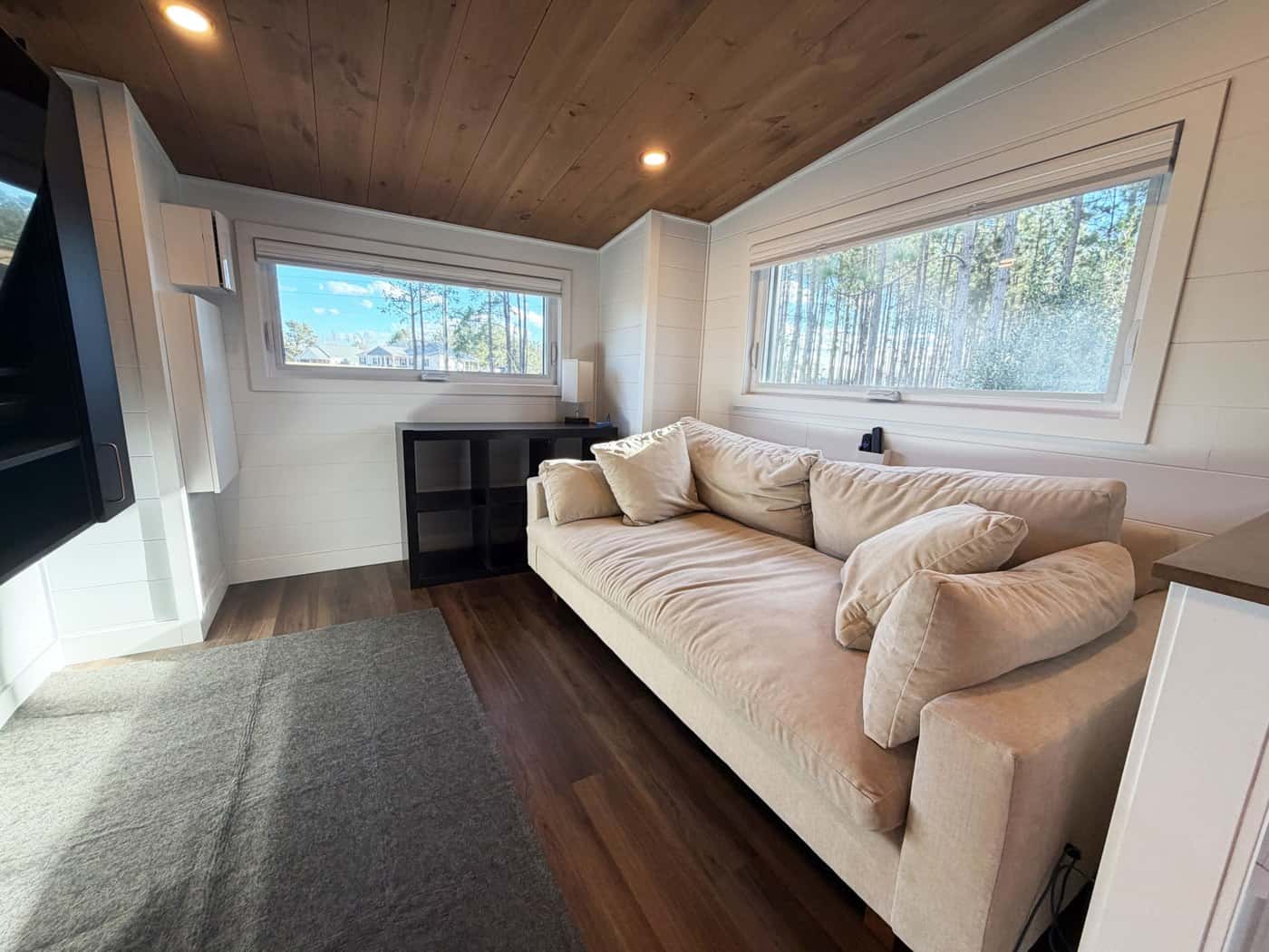 Elevated living room with a large sectional sofa and entertainment wall