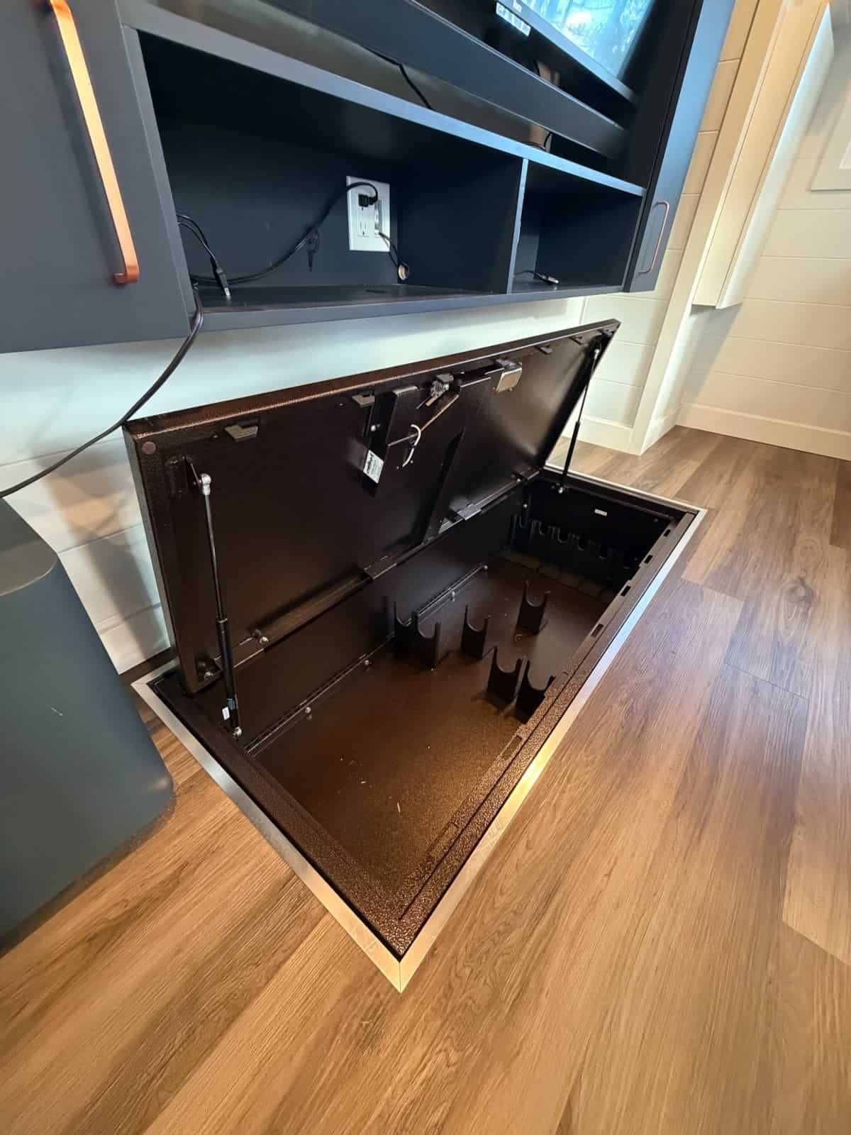 Hidden floor safe with a lift-up lid set flush into the tiny house floor