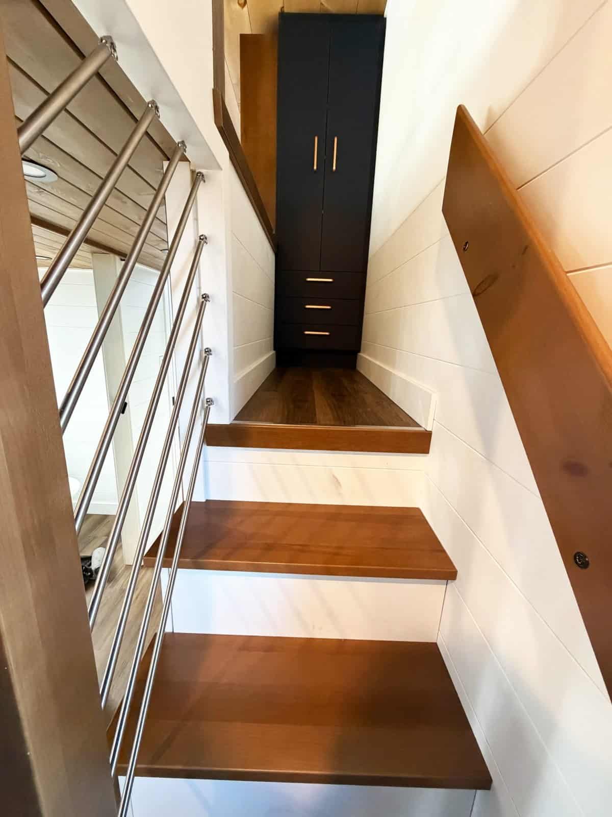 Wood staircase with integrated storage leading to the sleeping loft