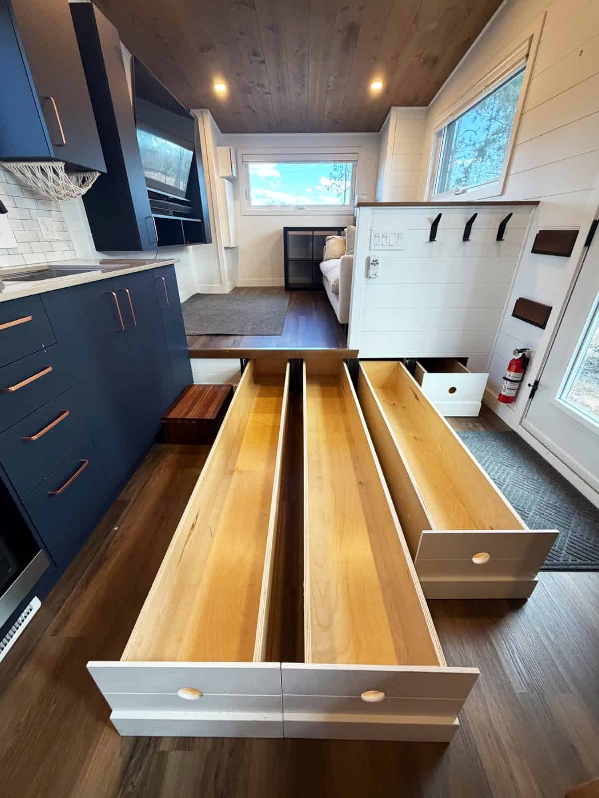 Seven foot deep pull-out storage drawers under the raised living room floor