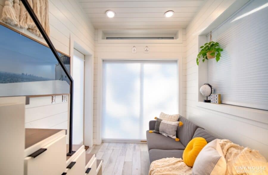 Cozy shipping container home interior with bright natural light and modern decor.