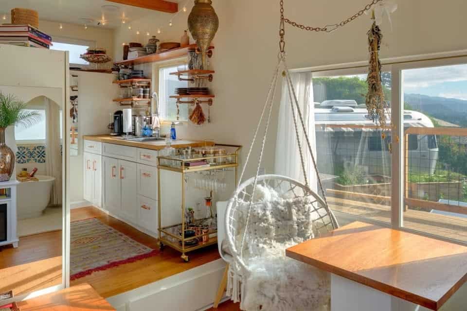 Kitchen and living space with swing chair and bar cart in the Moroccan tiny house