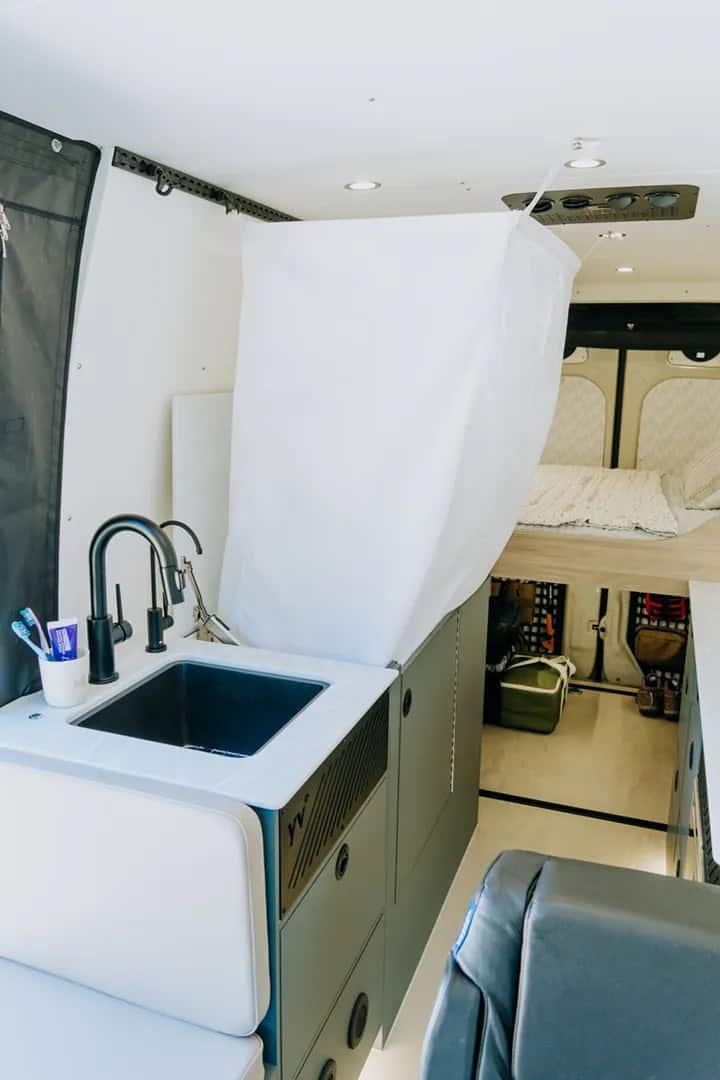 Sideways sleeping platform with dual-density mattress in the Nanuq Logan01N van