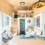 Cozy tiny home interior with natural wood finishes and smart space utilization.