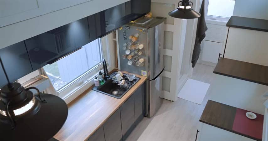 Kitchen from above with a sink, fridge, and dark cabinets