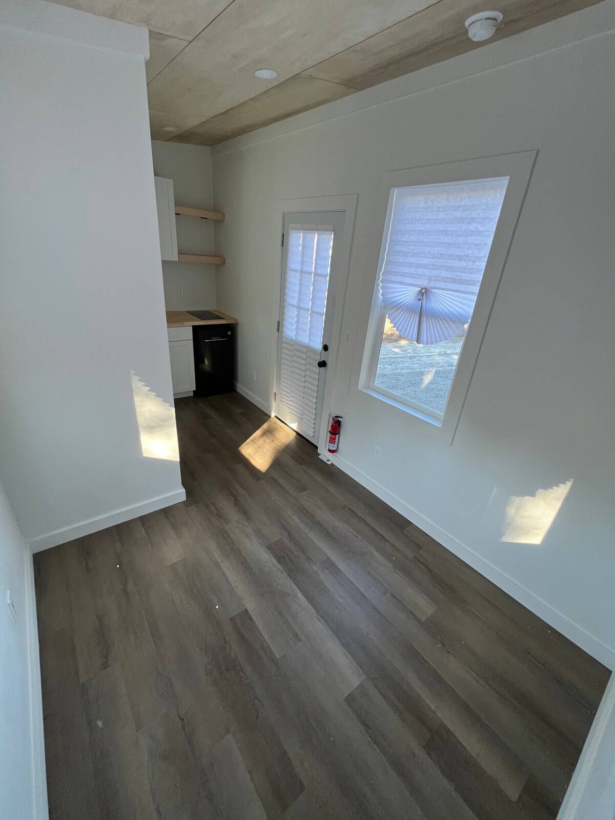 Bright open interior of the NOAH certified tiny house with wood plank ceiling