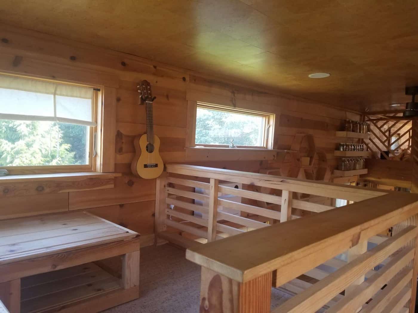 Built-in wood bench seating with slatted backs in the tiny house living area