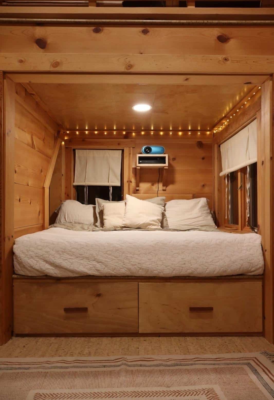 Main sleeping loft with a king mattress over built-in storage drawers