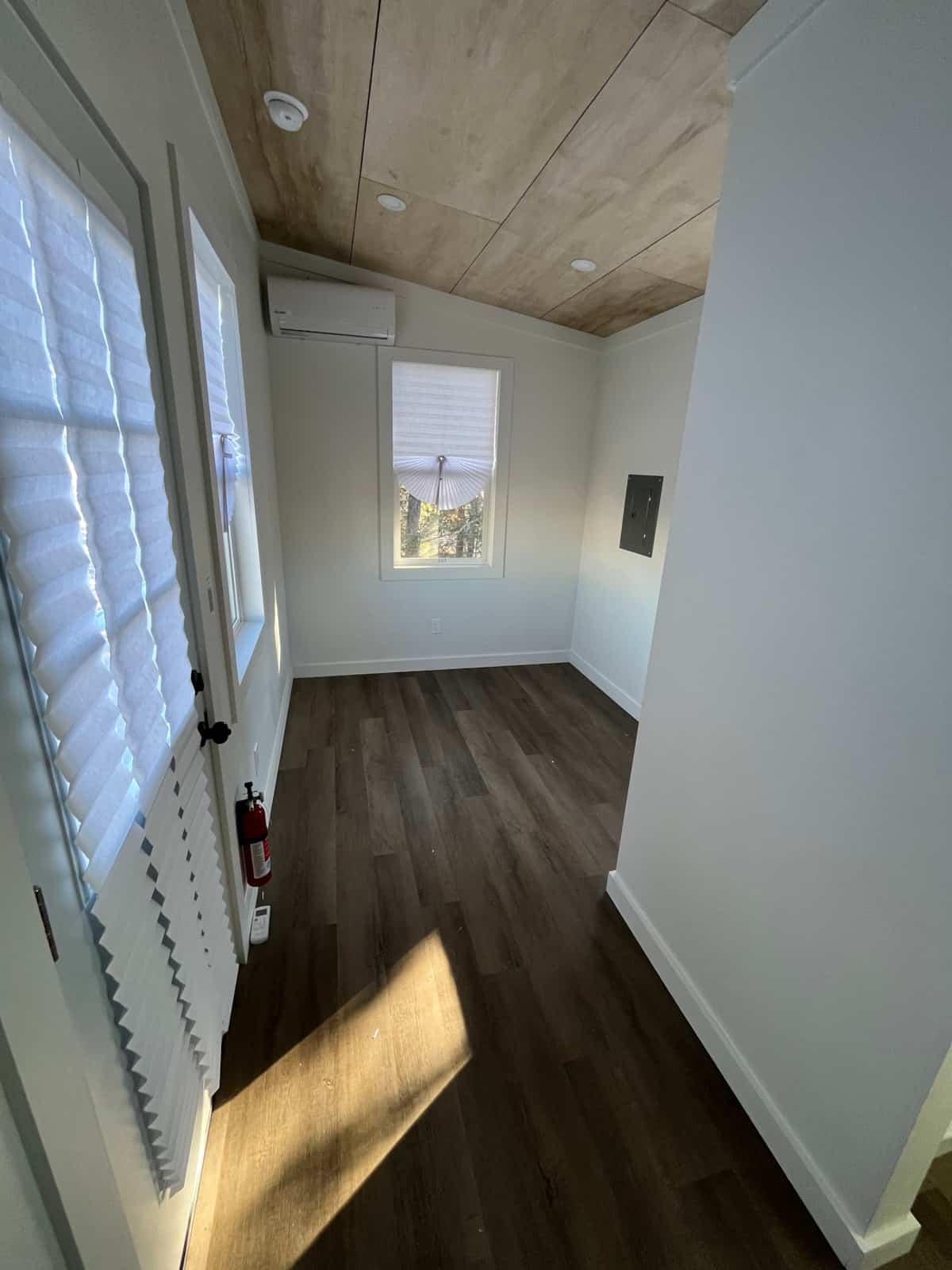 Open main room of the NOAH certified tiny house with mini split and windows