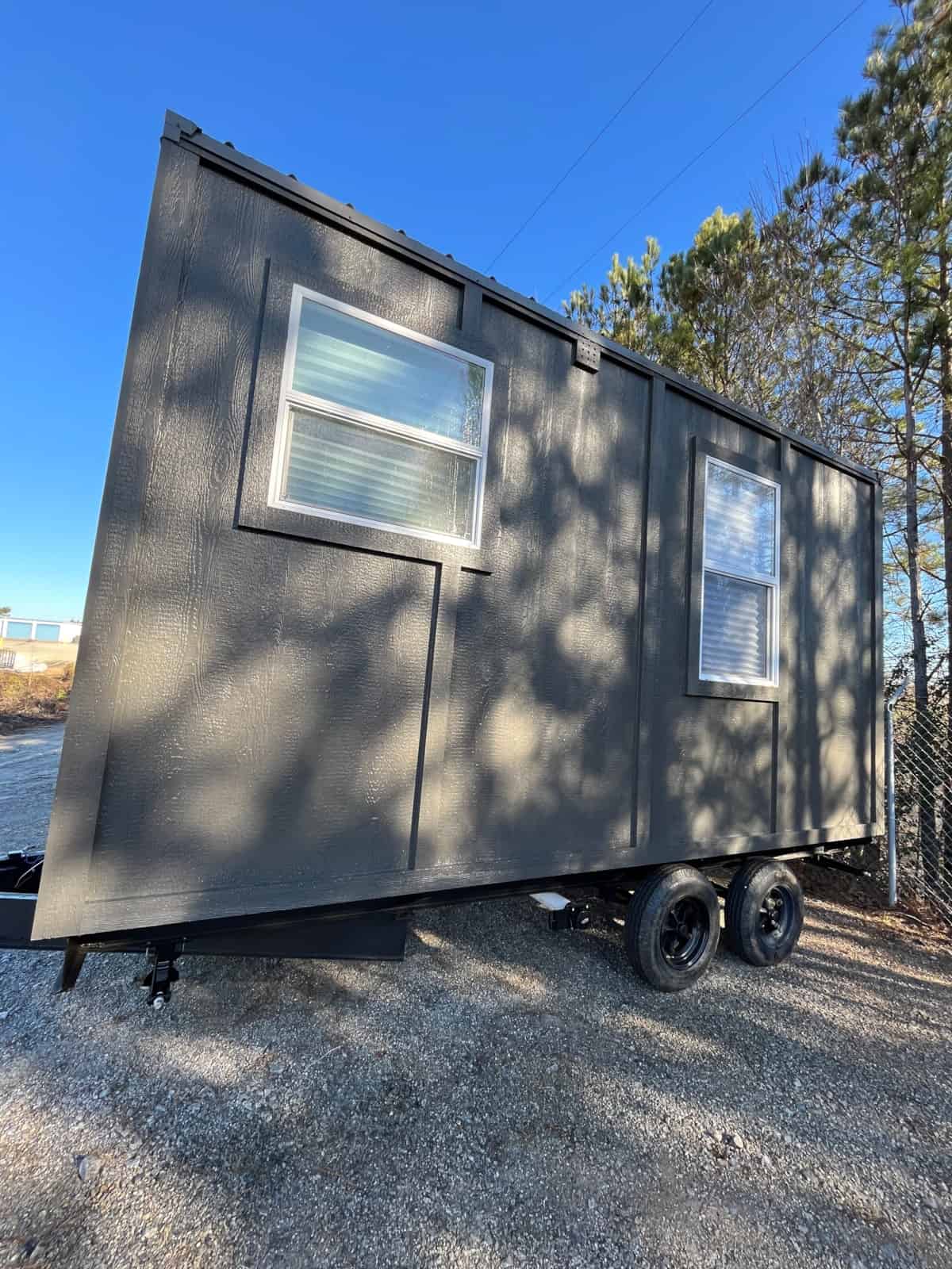 Side profile of the NOAH certified tiny house on wheels on its trailer