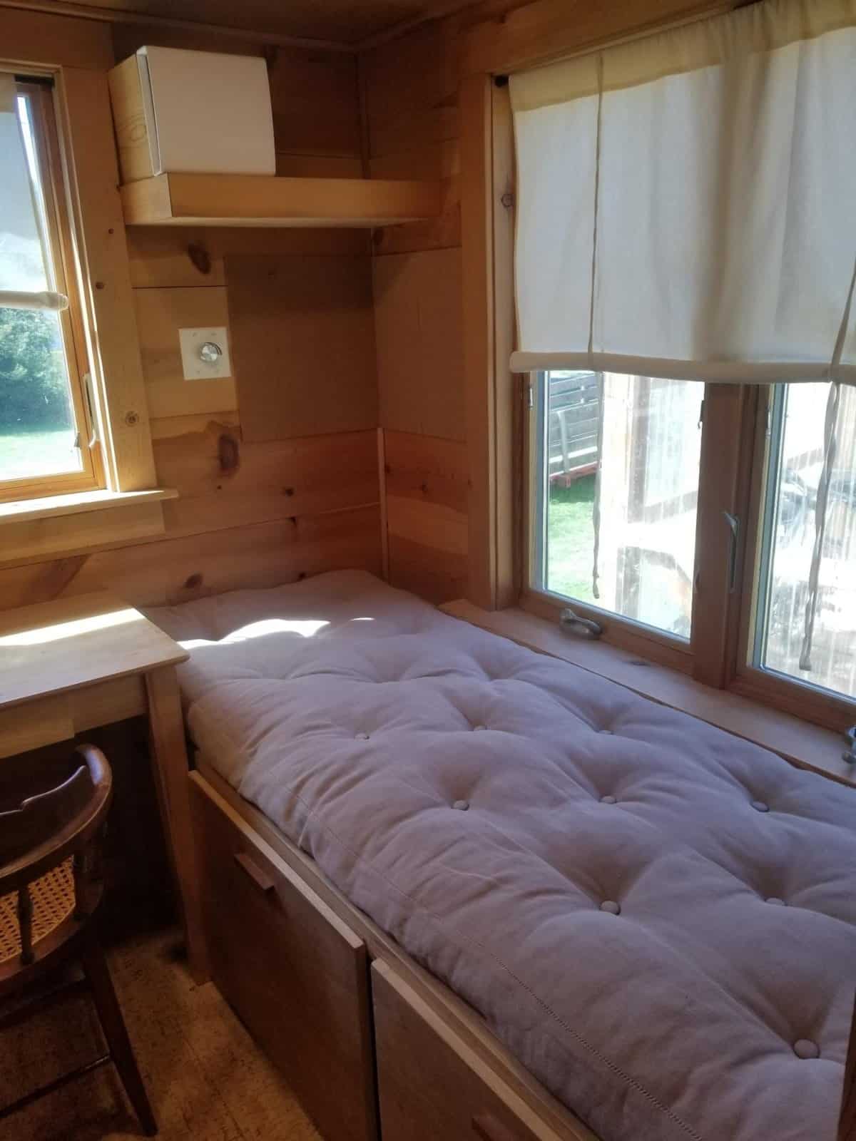 Deep window daybed with a natural cotton cushion in the tiny house