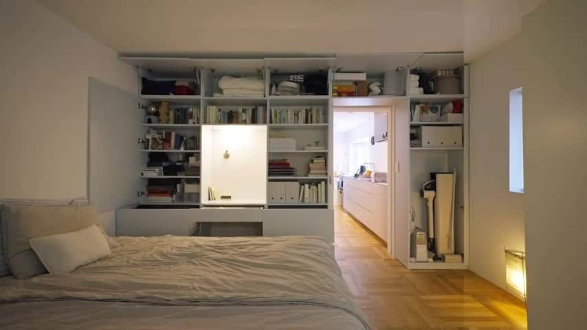 Bedroom with a bed and an open storage wall