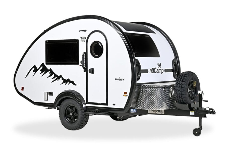 White 2026 nuCamp TAB 320 Boondock Edition teardrop, three-quarter studio: porthole door, mountain graphic, diamond-plate tongue box, spare tire