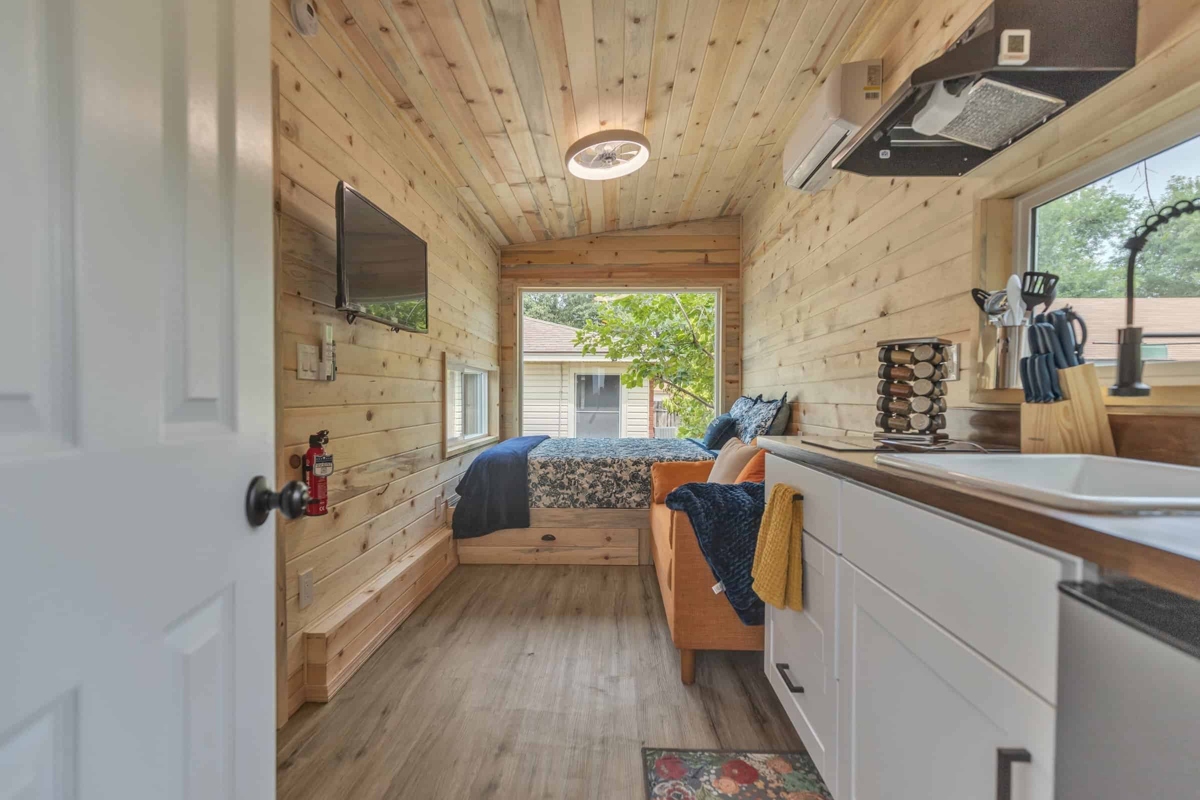 Pacifica Model X tour interior still: wood walls, open studio layout