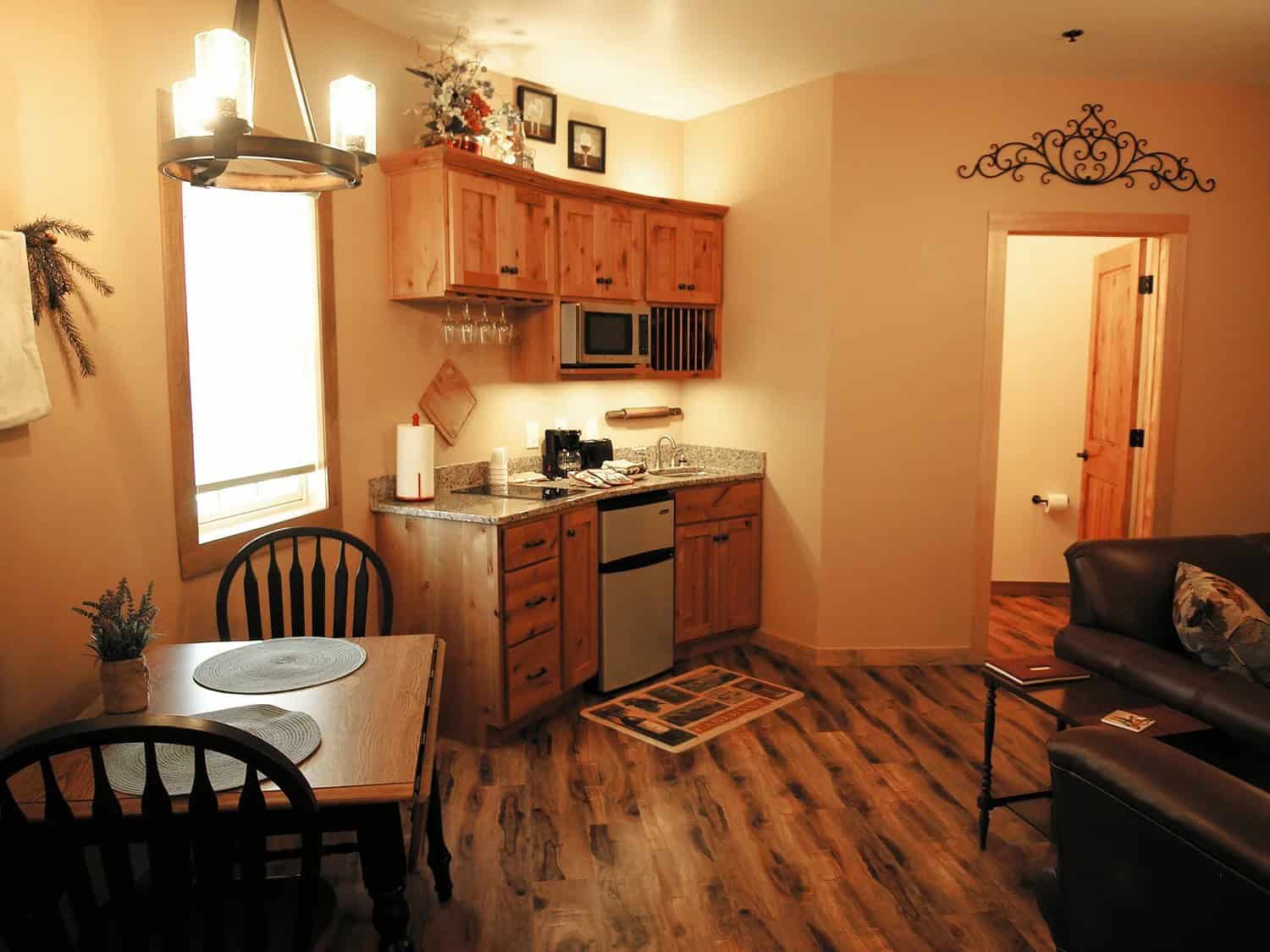 Furnished kitchenette and dining tables inside a Patoka Silo Suite