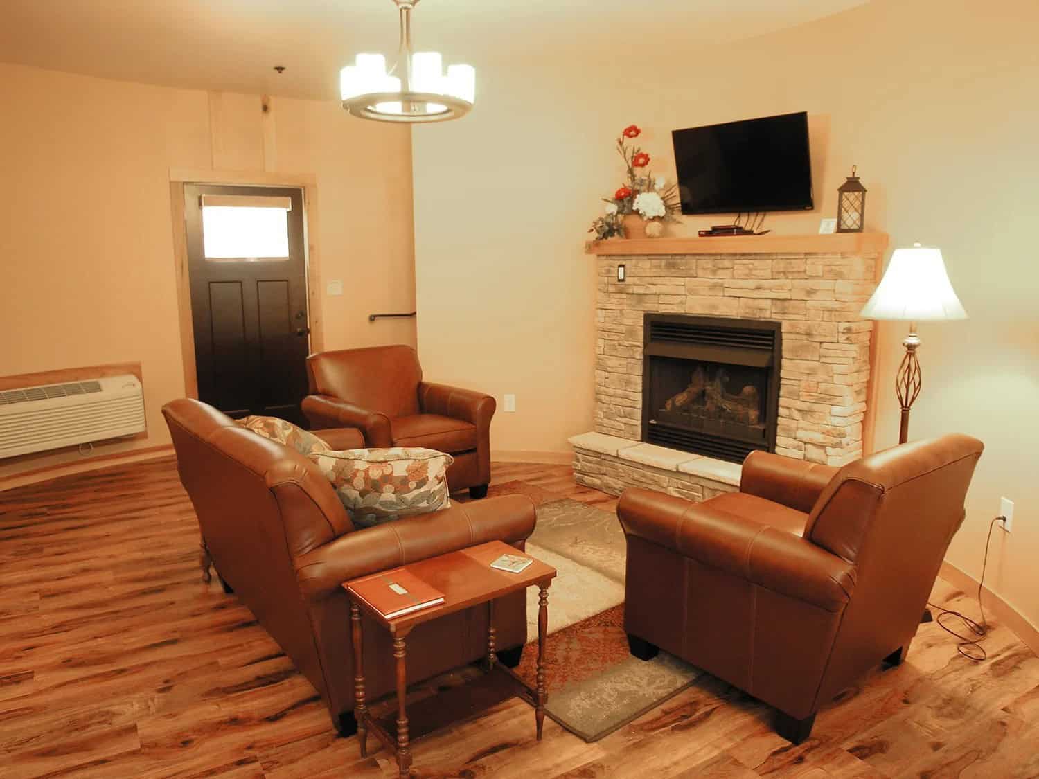 First-floor living area with fireplace inside a round Patoka Silo Suite