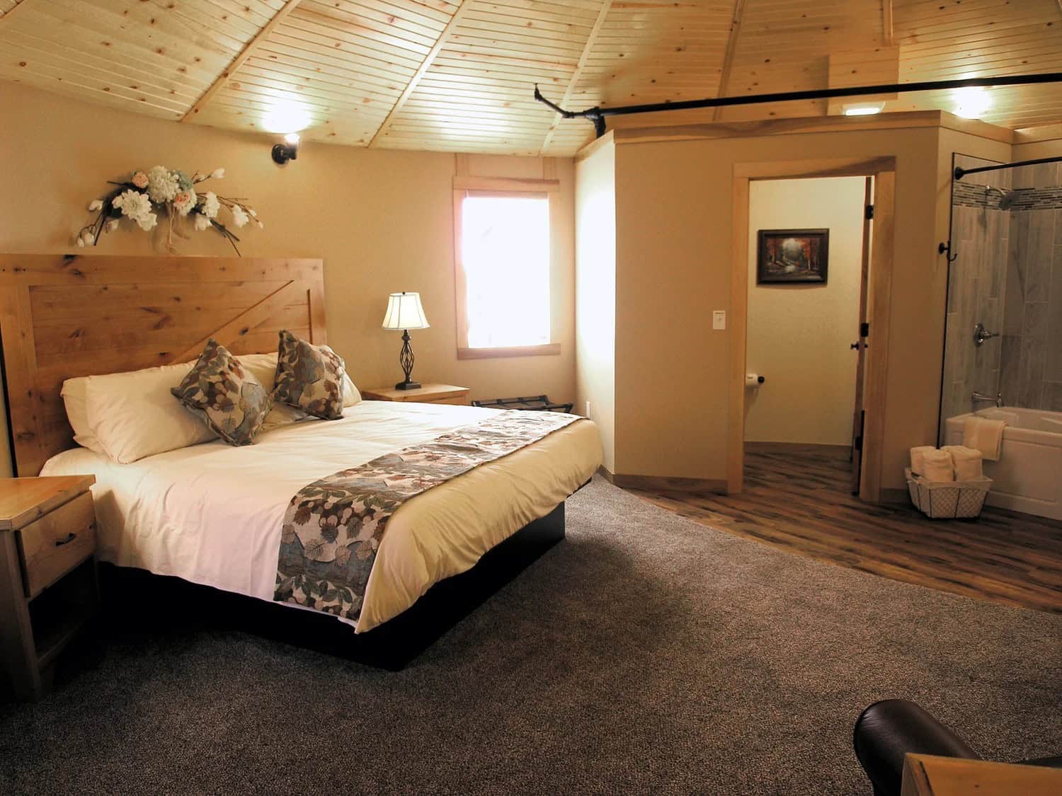 Upstairs king bed inside a round Patoka Lake Winery Silo Suite