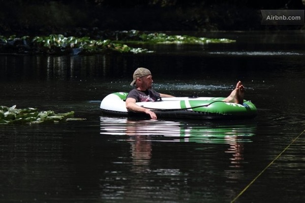 Relaxing on an inflatable raft in the pond