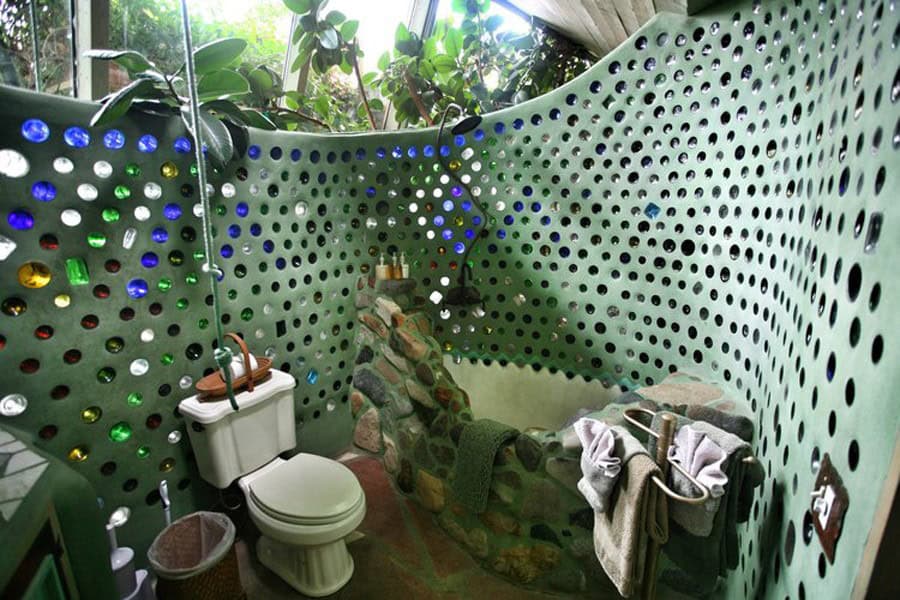 Bathroom with a stone tub and a bottle wall
