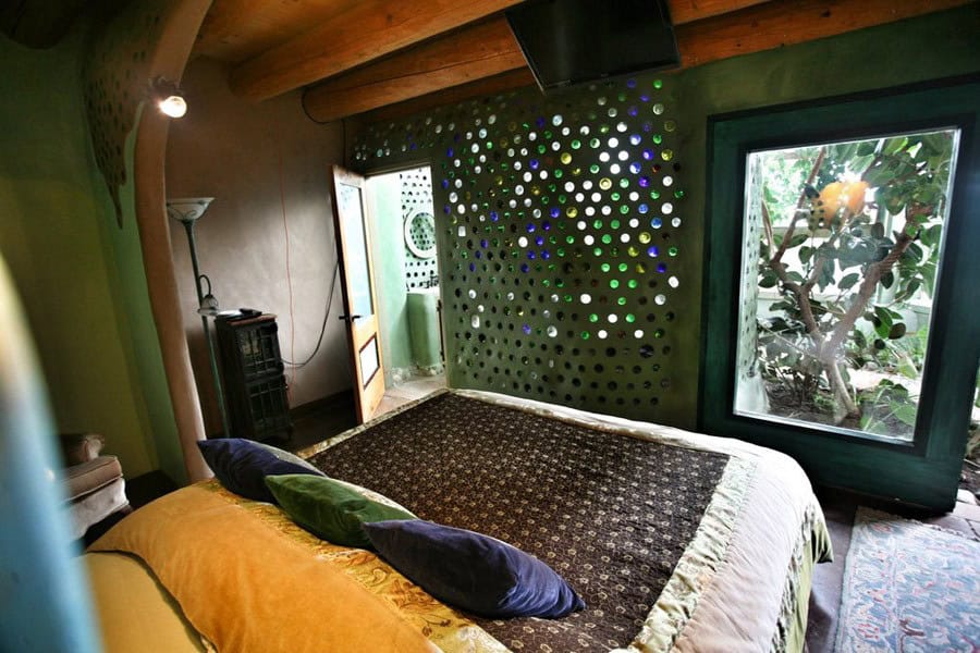 Bedroom with a bottle wall and a greenhouse window