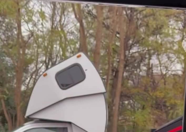 Close-up of the angular cab-over sleeper pod with a small tinted side window and amber marker lights — still from the Pless Trucking reel