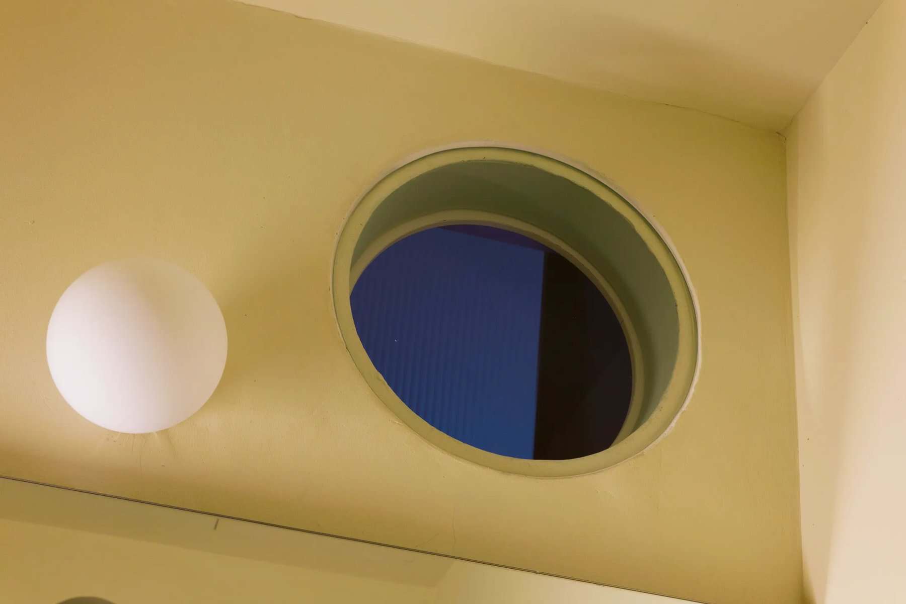 Round porthole window in the shower for ventilation