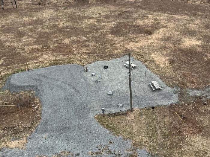 Overhead view from the tower of gravel base campsite with picnic tables and fire ring at Red Oak Fire Lookout