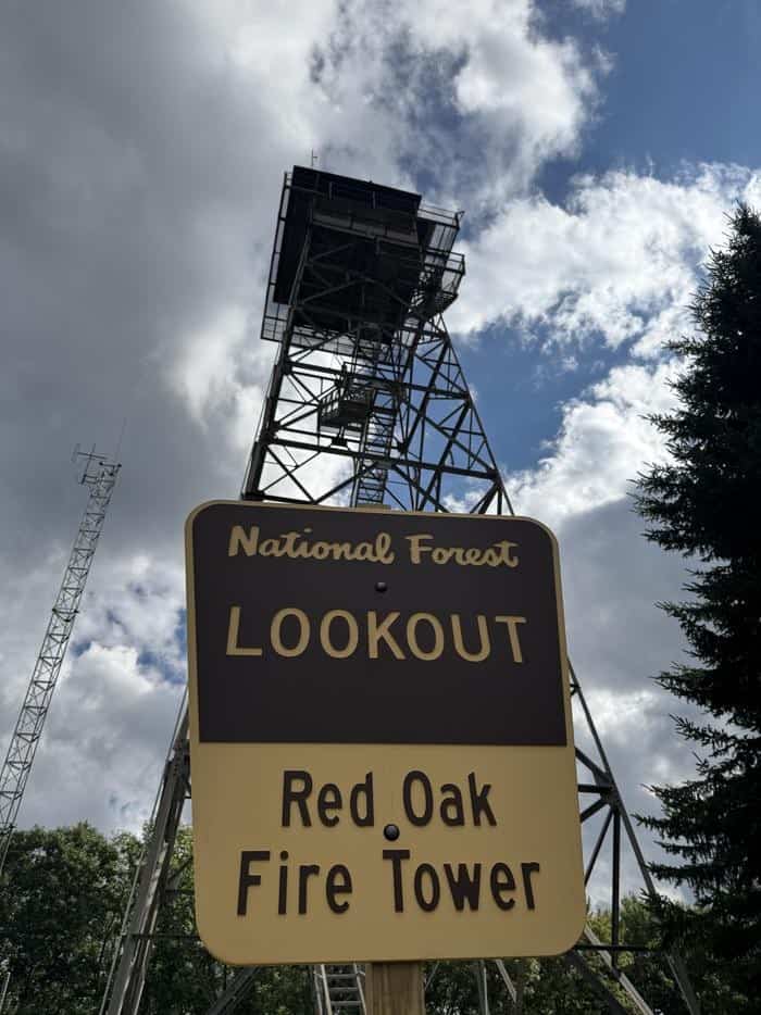 Daylight exterior of Red Oak Fire Tower with LOOKOUT National Forest sign, Webster County West Virginia