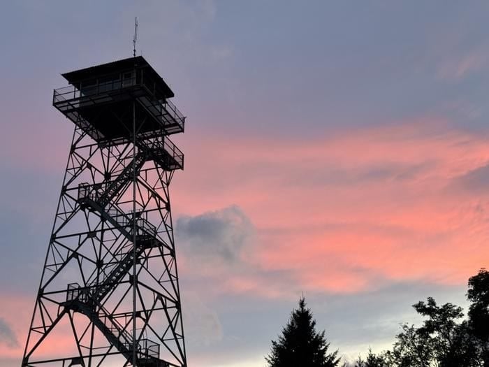 Sunset silhouette of Red Oak Fire Lookout tower against evening sky, Monongahela National Forest