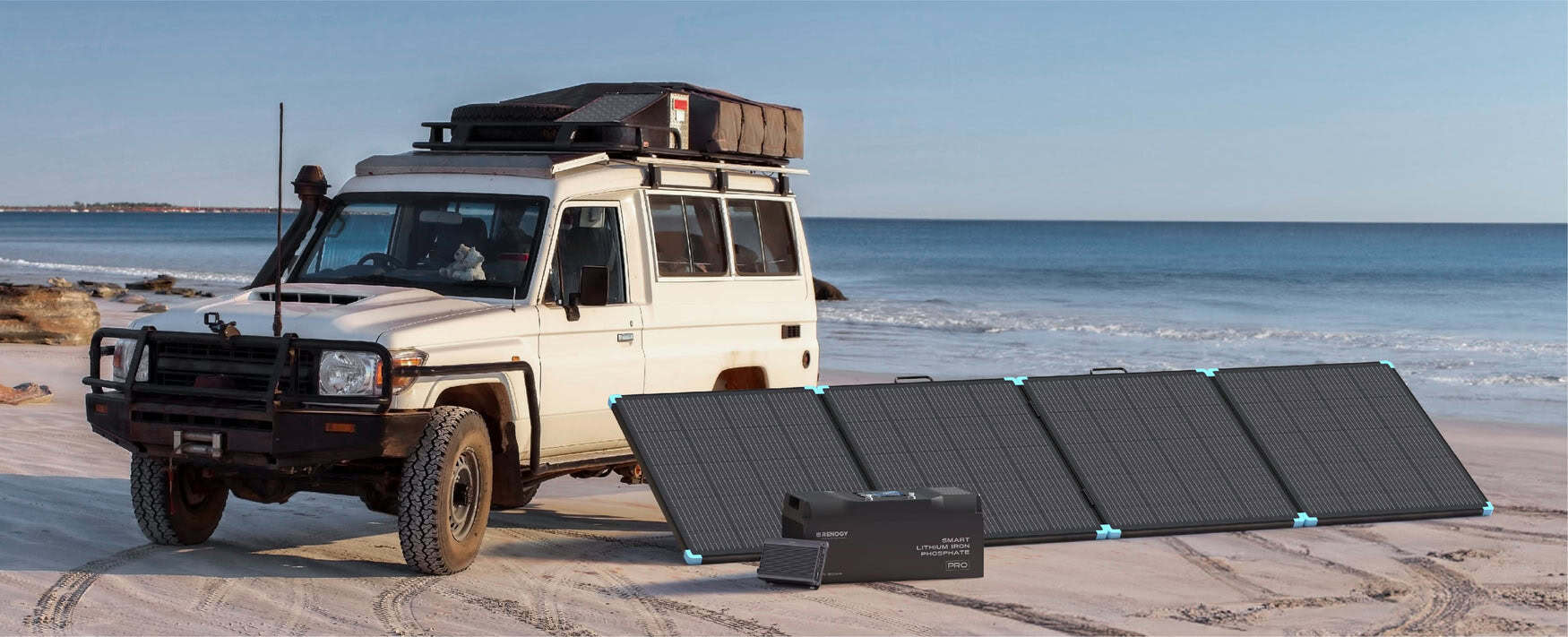 Renogy portable solar panel and LiFePO4 lithium battery powering an overland vehicle at the beach