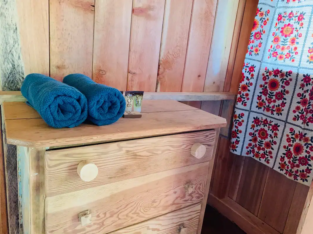 Dresser with towels and toiletries in the King Wood Cabin