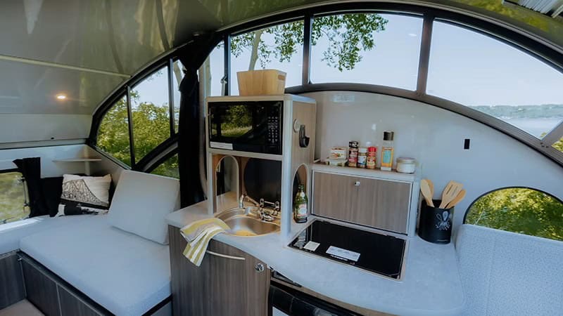 Alto R1713 sink and cooktop under panoramic curved windows with roof raised, Safari Condo