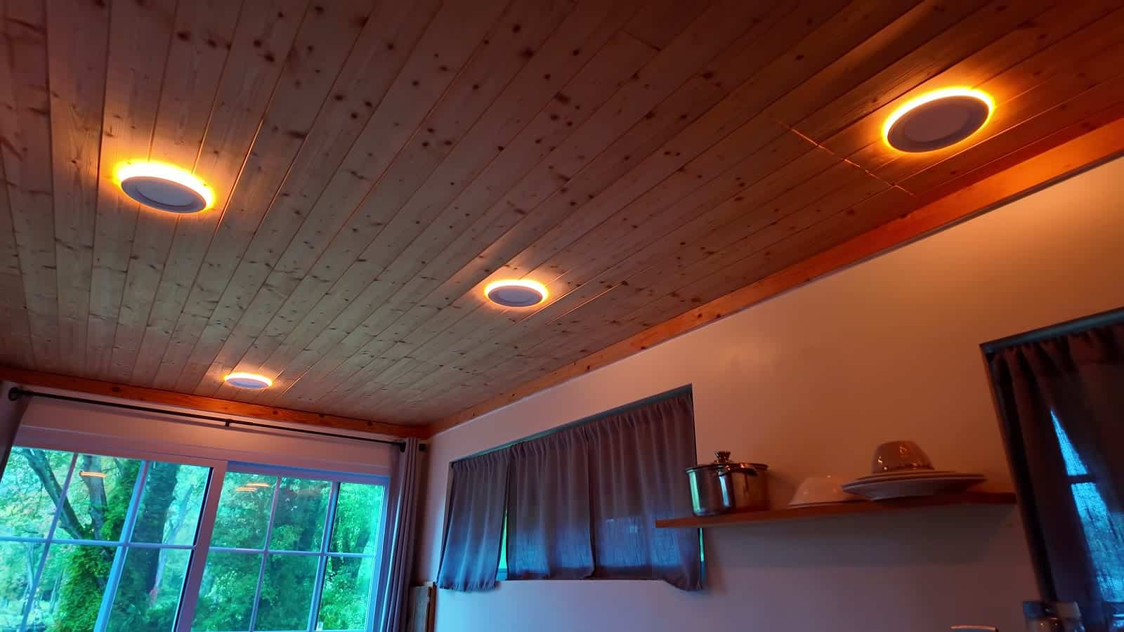 Color-changing ceiling lights glowing orange in a container cabin at night