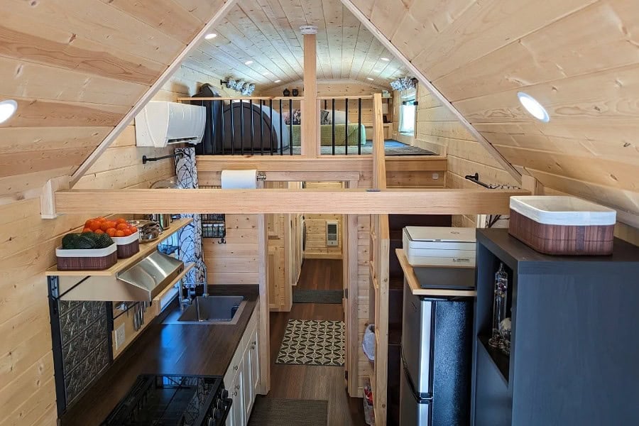 Interior overhead view showing kitchen, living area, and loft access