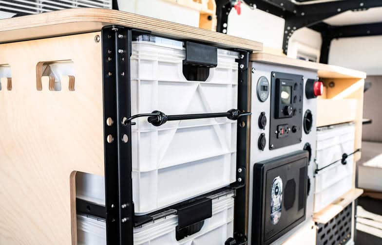 Compact electrical panel and storage system in a tiny house interior.