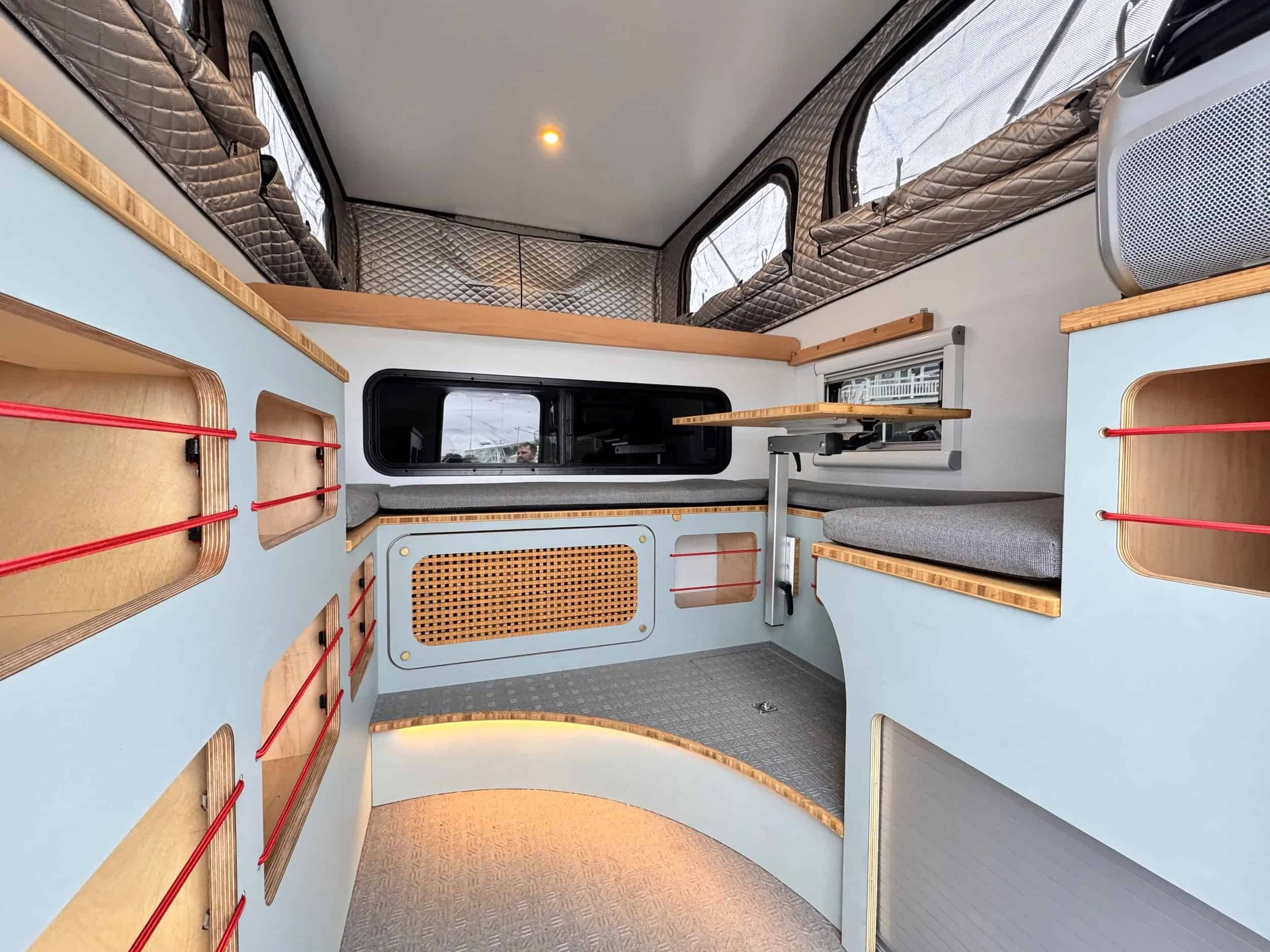 Big Ripper truck camper interior lounge and galley, pop-top up
