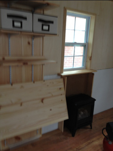 shirleys-mortgage-free-tiny-house-interior-construction-fireplace-table-storage