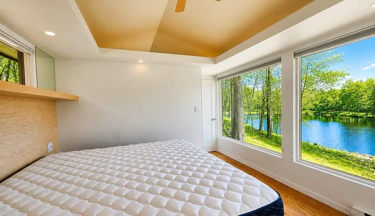 King bedroom with its own corner glass wall facing Lost Lake in the SHORELINE Glass House Lot 21