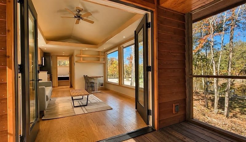 Screened porch with open glass French doors leading into the living room of the Shoreline Lot 19