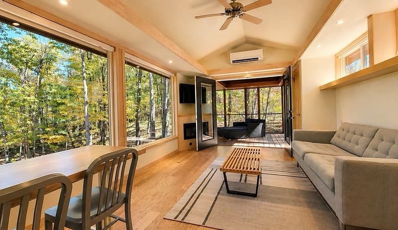 Living room with floor-to-ceiling glass, electric fireplace, and Smart TV in the Shoreline Lot 19