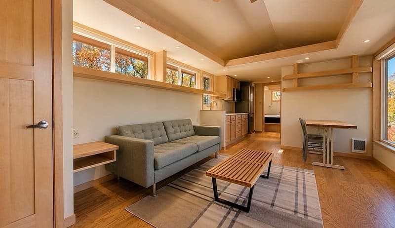 Open-concept living space with maple trim, oak floors, and clerestory windows