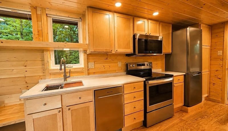 Gourmet kitchen with quartz countertops, full-size stainless range, dishwasher, and abundant cabinetry at the Shoreline Lot 23