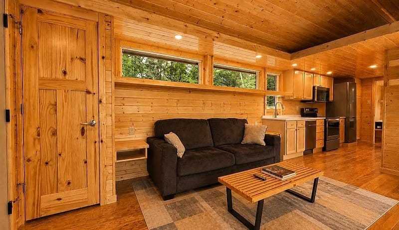 Open living area with an optional sleeper sofa and clerestory windows opening to the kitchen at the Shoreline Lot 23