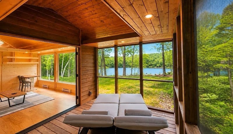 Spacious screened porch with loungers overlooking Lost Lake at the Shoreline Lot 23