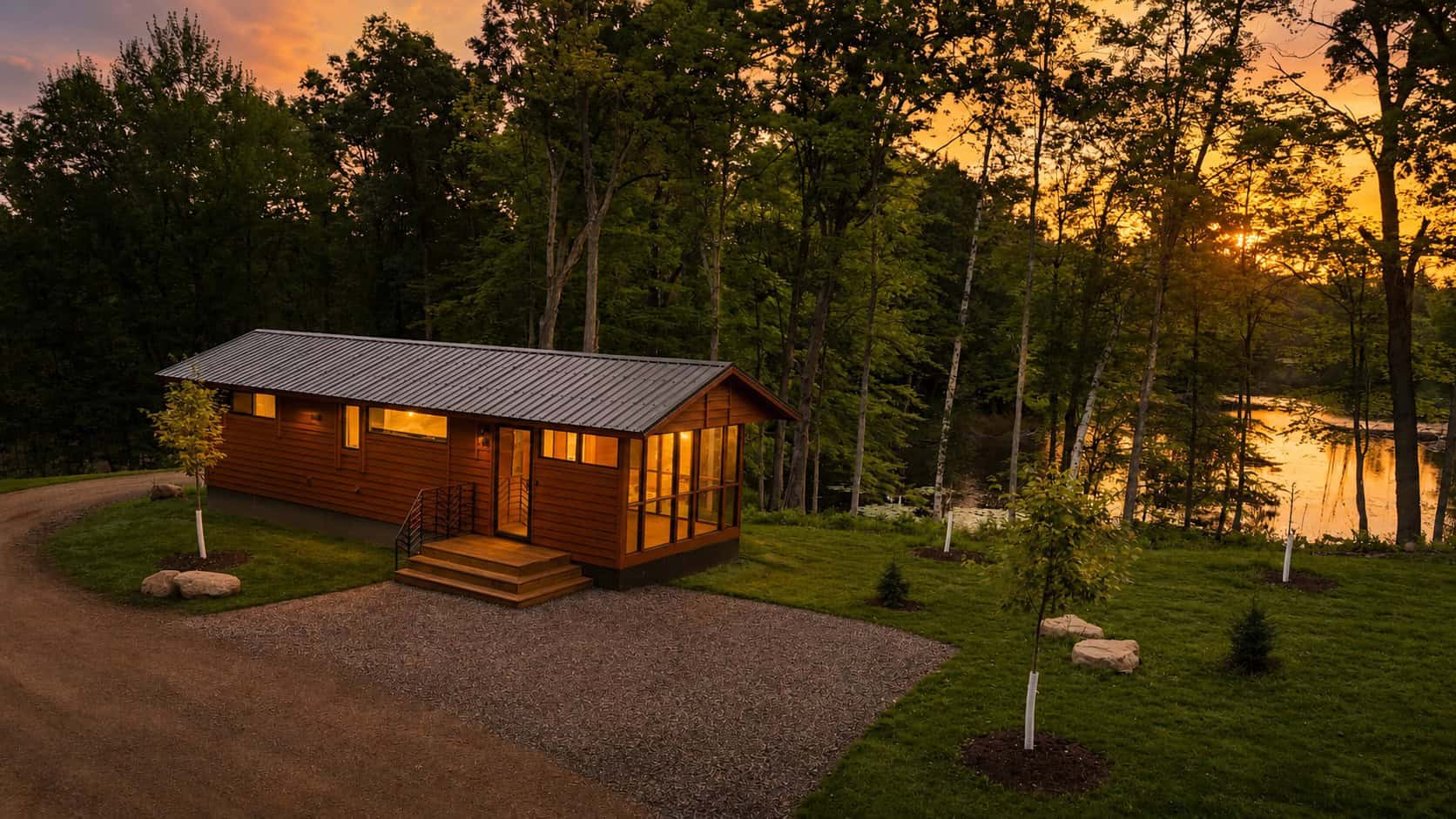 Shoreline cabin exterior with wood siding, metal roof, and screened porch at sunset on Lost Lake, Canoe Bay Village Lot 24
