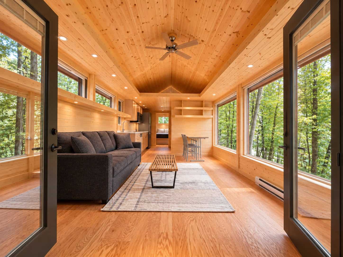 Living room with dramatic windows at Shoreline XL Lot 26 Canoe Bay Village